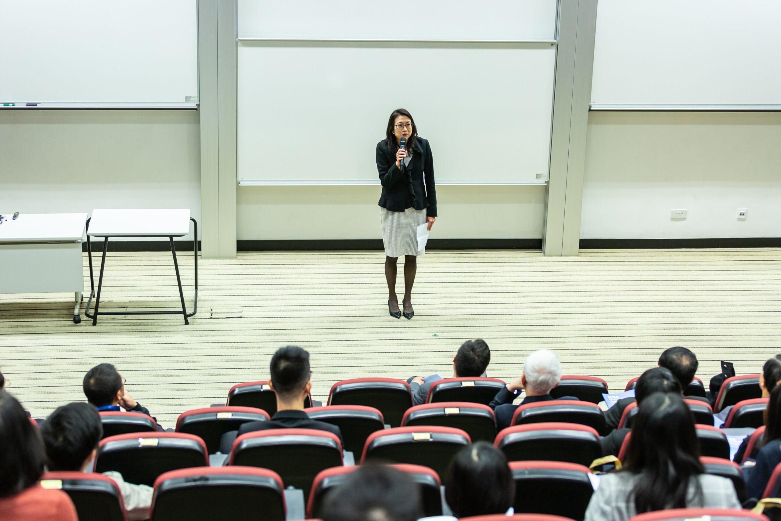 Women speaking in lecture hall